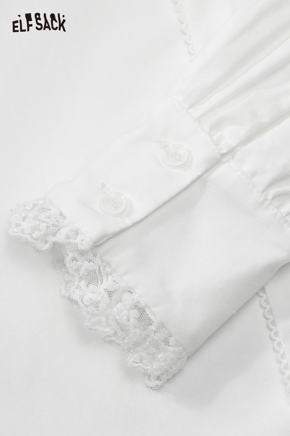 Close-up of ELFSACK elegant ruffle collar white shirt with lace detailing on cuffs and buttons