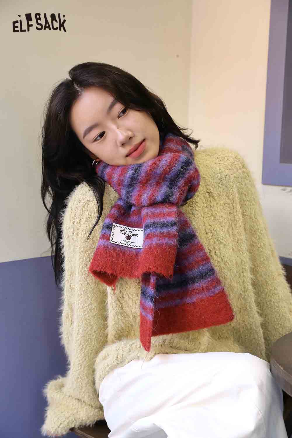 Cozy Christmas striped scarf for women in vibrant colors, paired with a soft sweater for a festive look