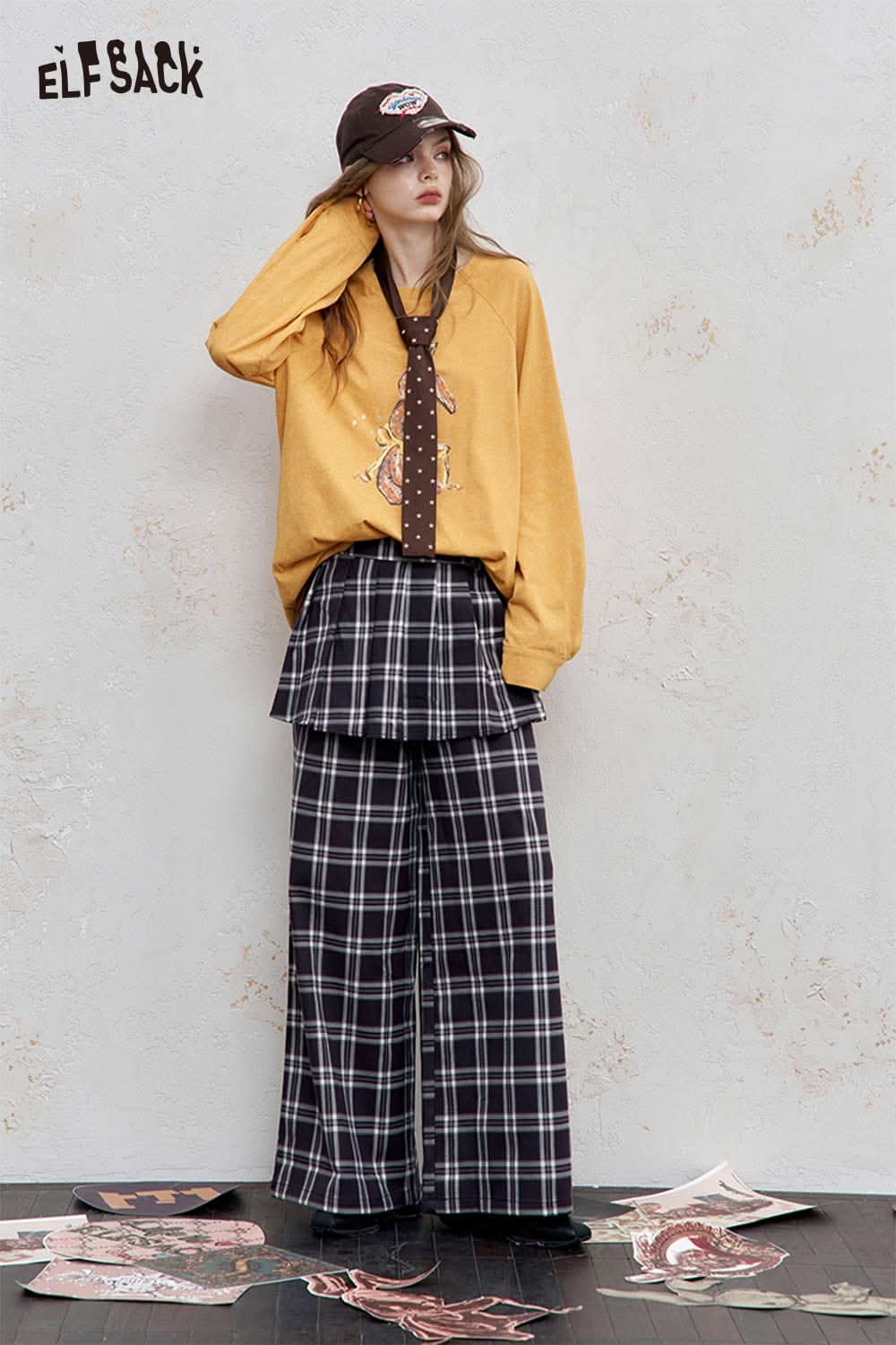 ELFSACK organic cotton embroidered long sleeve tee in yellow, styled with a plaid skirt and cap