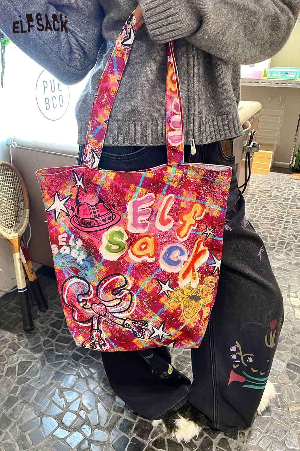 Vibrant plaid graffiti tote bag by ELFSACK featuring colorful designs and sturdy straps