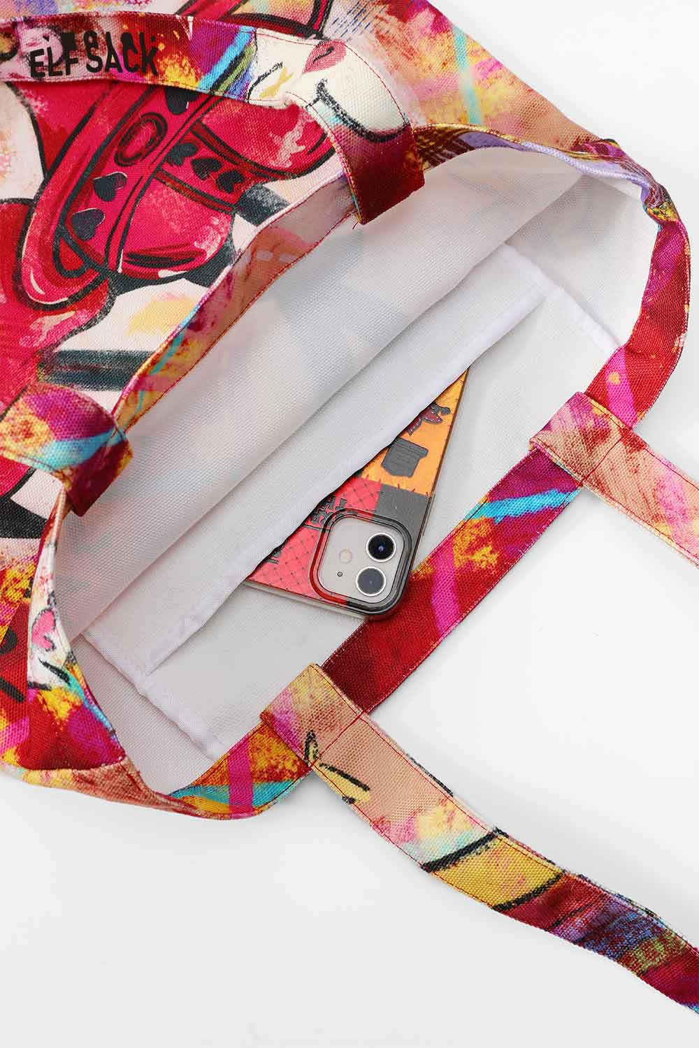 Interior view of the ELFSACK plaid graffiti tote bag with a smartphone inside