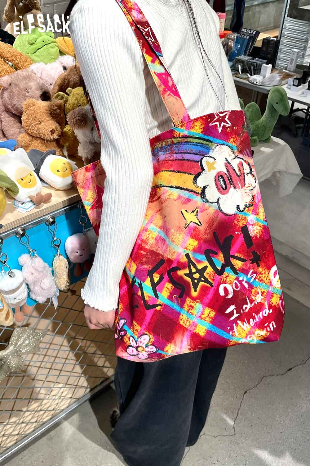 Vibrant ELFSACK plaid graffiti tote bag with colorful design and roomy shoulder straps