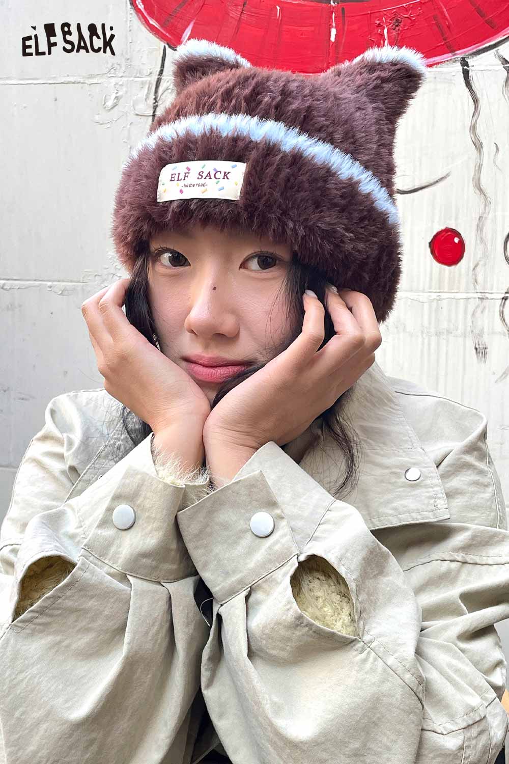 Cozy ELFSACK plush cat ear hat for women in brown with blue stripes, perfect for winter style