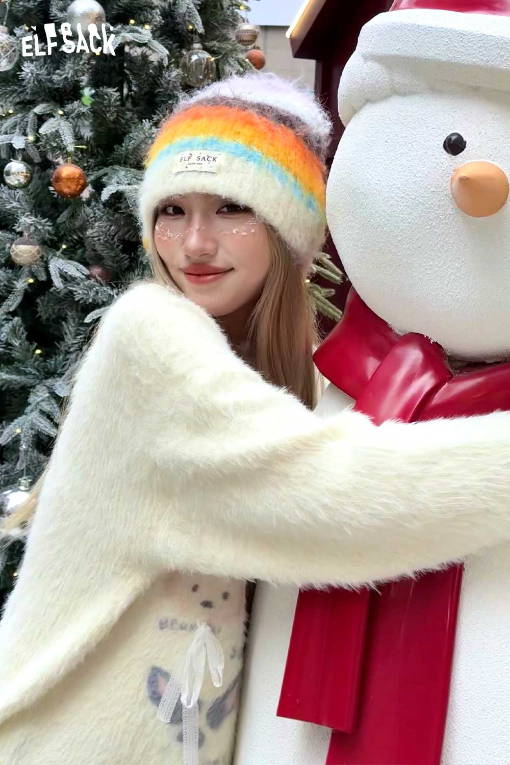 ELFSACK rainbow striped knit beanie worn with a cozy outfit, perfect for winter fashion