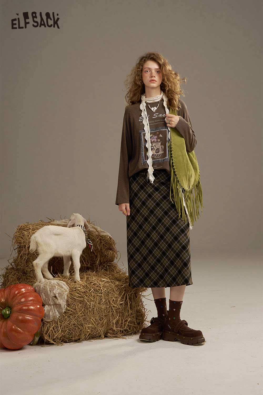ELFSACK soft printed raglan sleeve sweatshirt paired with a plaid skirt and brown footwear