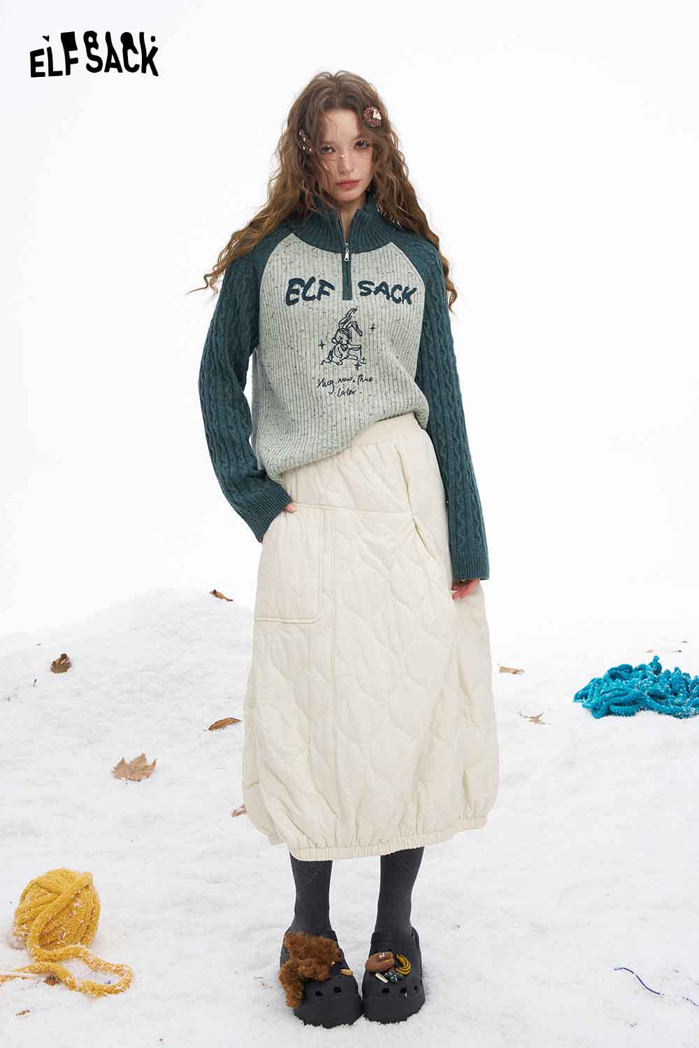 ELFSACK women's graphic color block knitwear with a zip neckline paired with a quilted white skirt