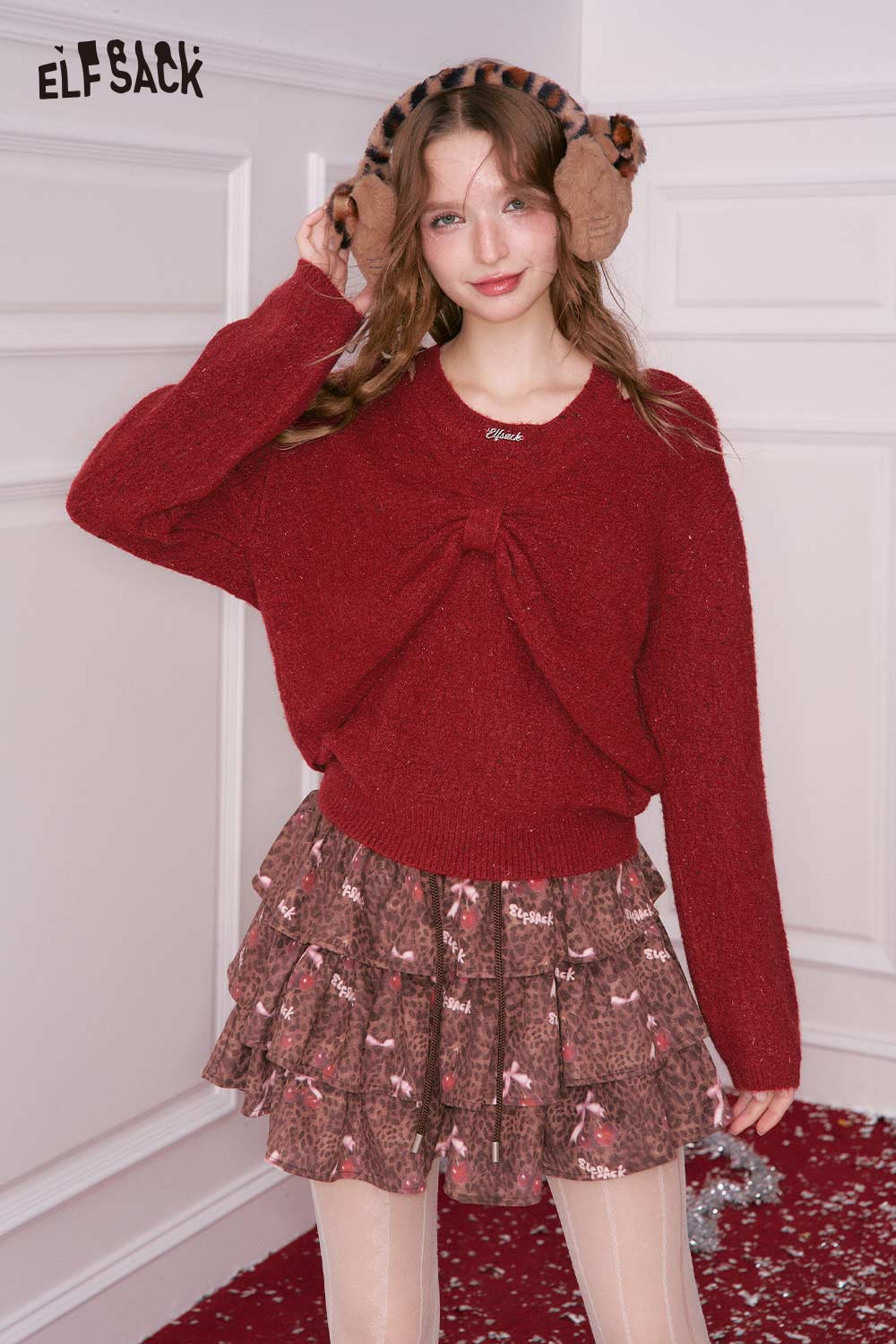 ELFSACK bow embellished cutout sweater in red, styled with a ruffled skirt for a trendy look