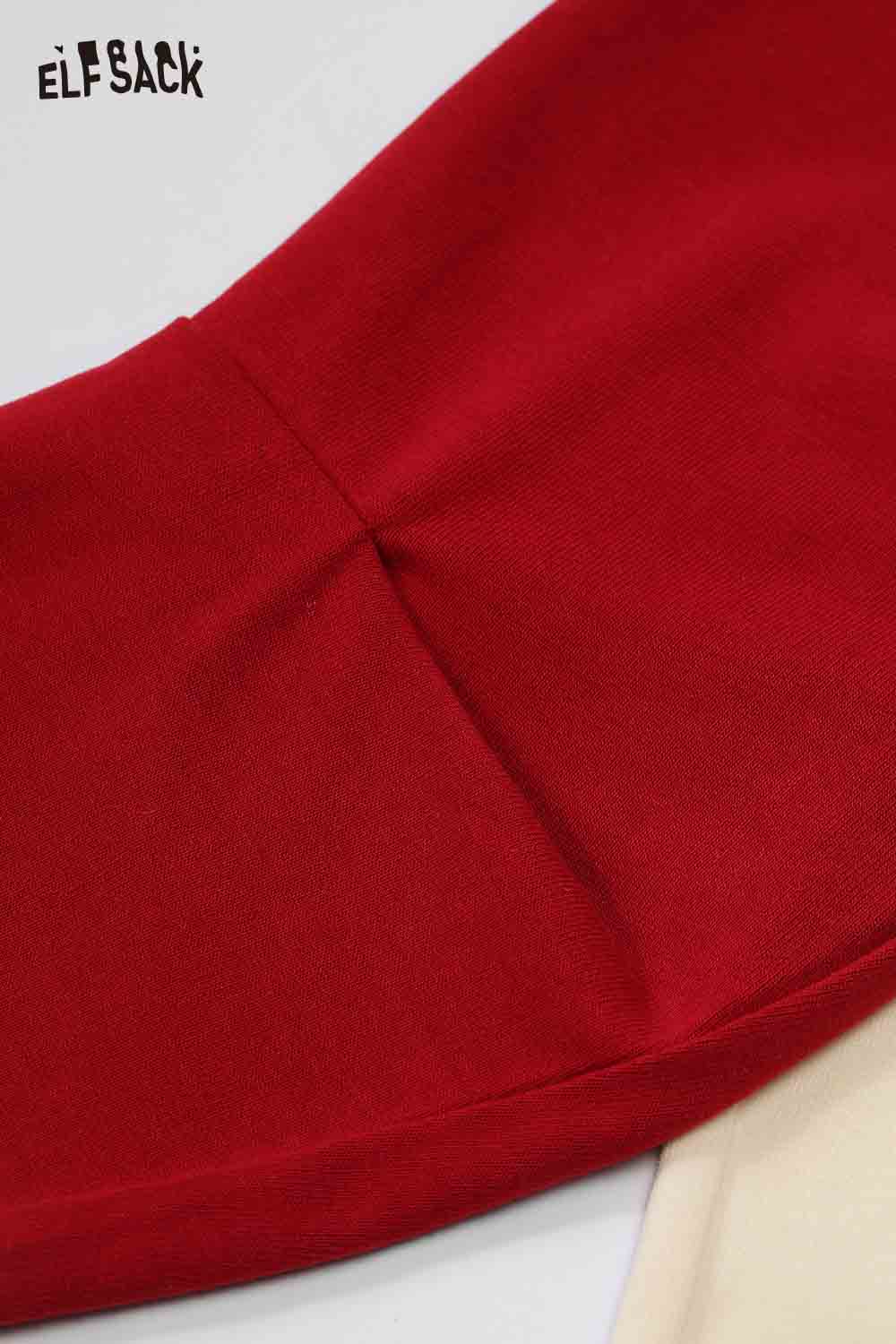 Close-up of ELFSACK color block raglan sleeve t-shirt in red and beige fabric detail