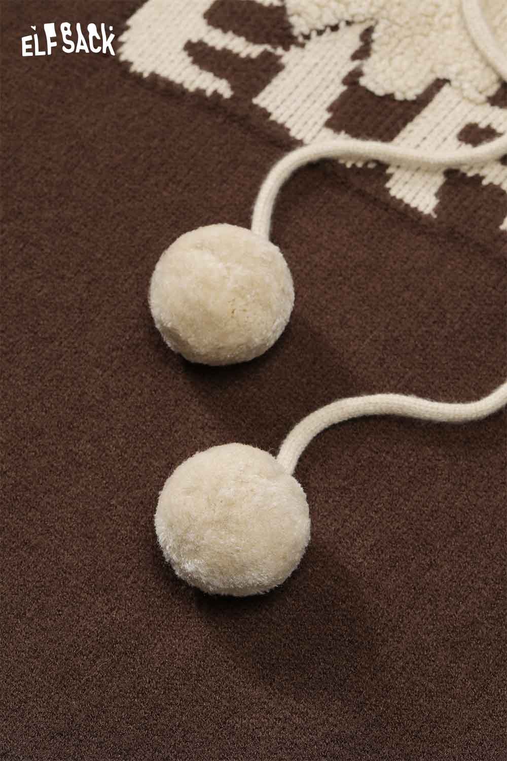 Close-up of ELFSACK cute graphic knit dress with soft pom pom details on the neckline