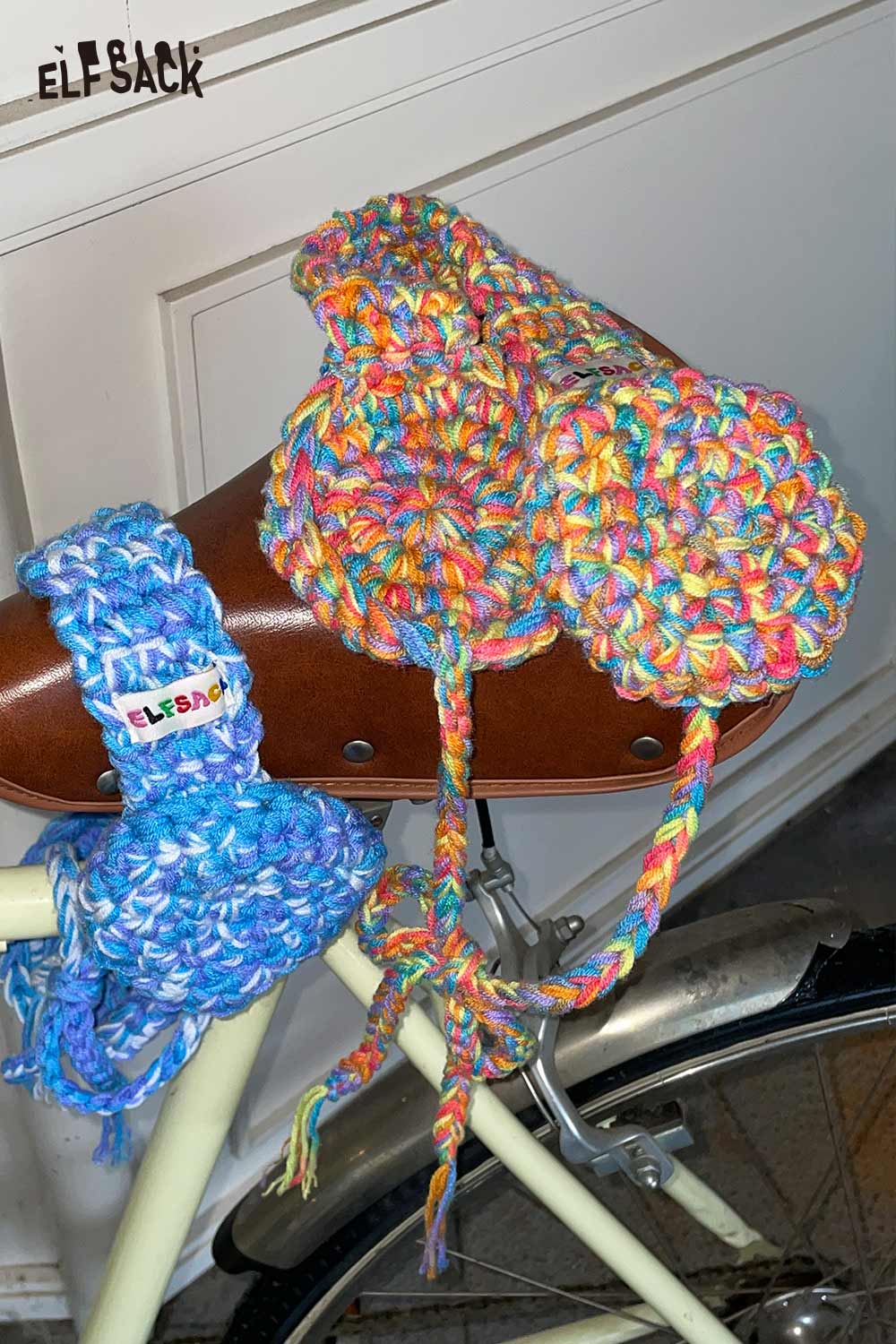 Colorful hand-knitted ear warmers displayed on a bicycle handle for stylish winter warmth