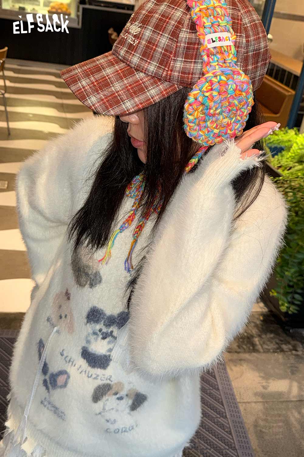 Vintage style ELFSACK hand-knitted ear warmers worn with a cozy sweater and plaid cap