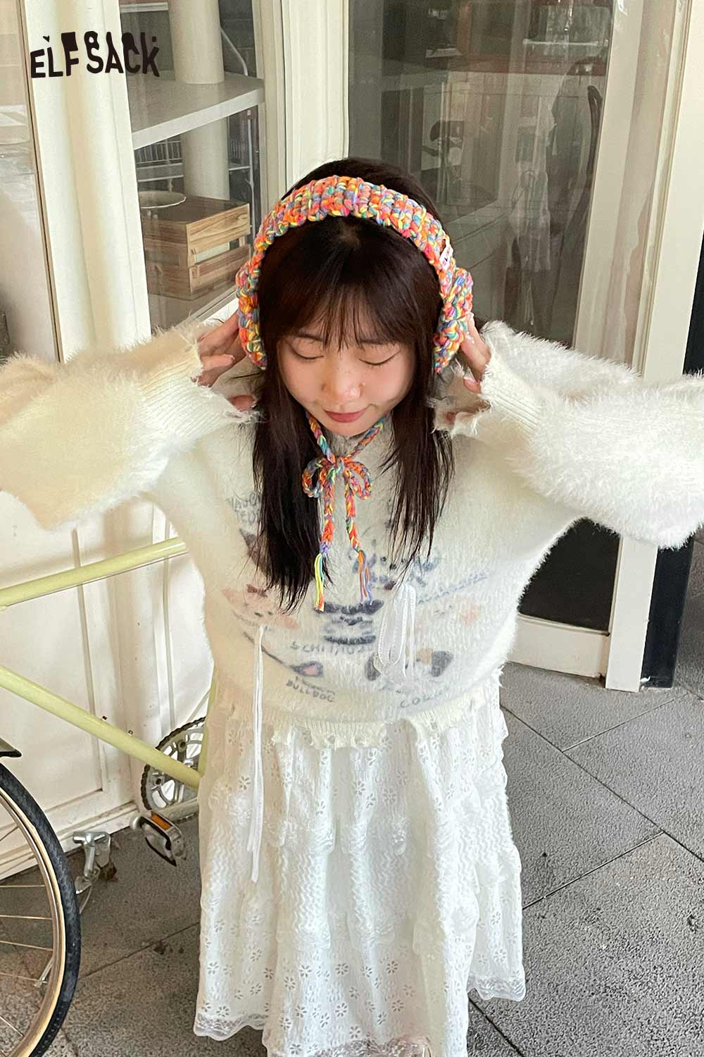 ELFSACK colorful hand-knitted ear warmers on a model with a cozy outfit and soft light background