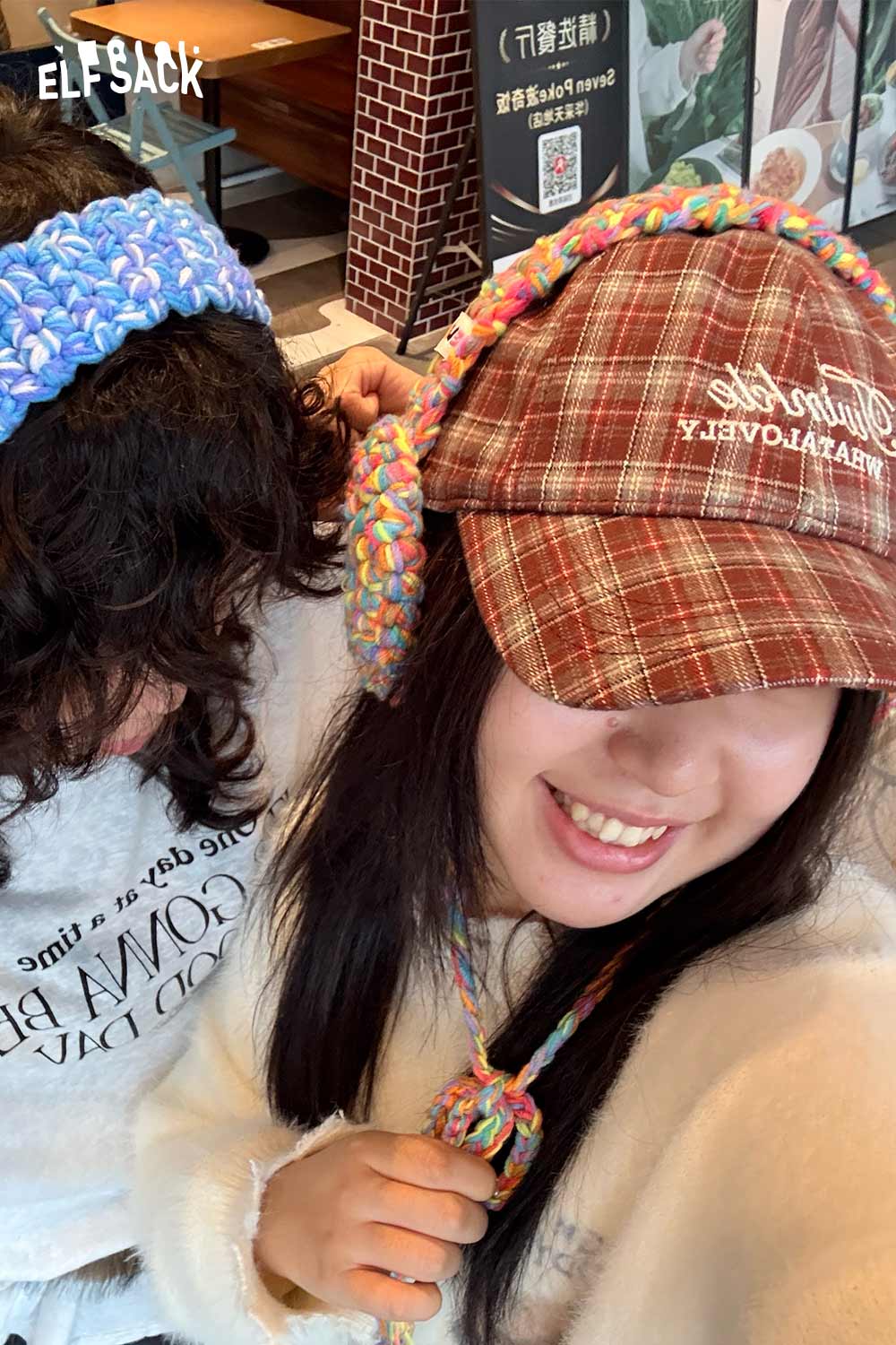 Two models wearing colorful hand-knitted ear warmers for stylish winter warmth