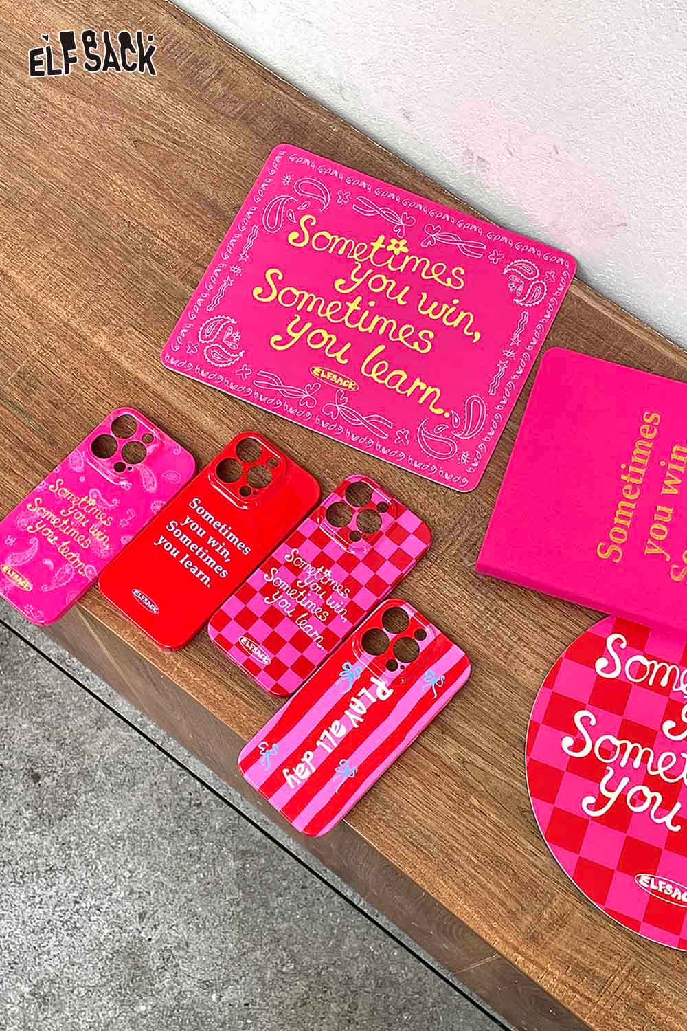 Colorful ELFSACK motivational quote mousepad with inspirational text on a wooden desk