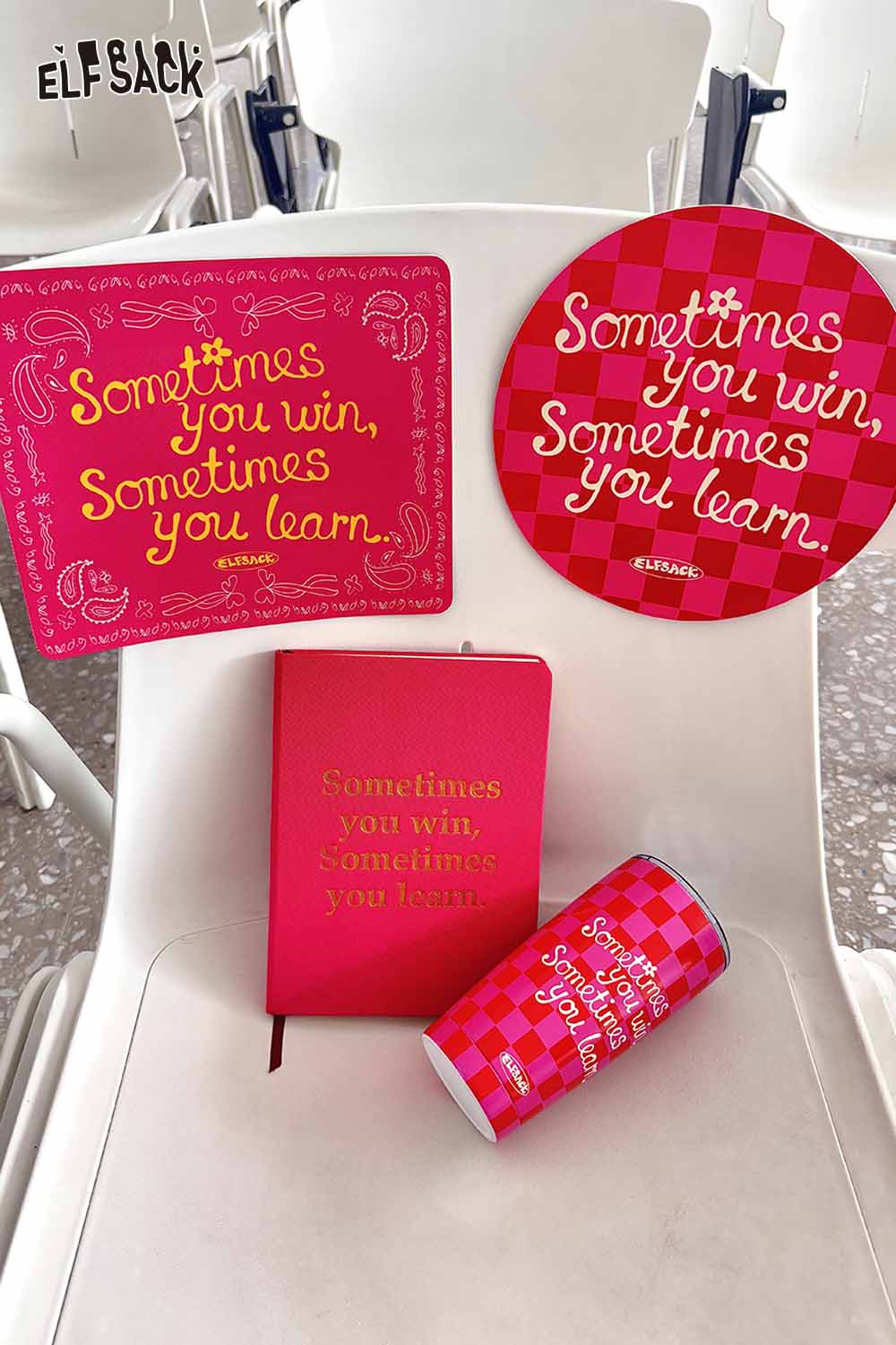 ELFSACK plaid stainless steel tumbler with inspirational text and matching accessories on a chair