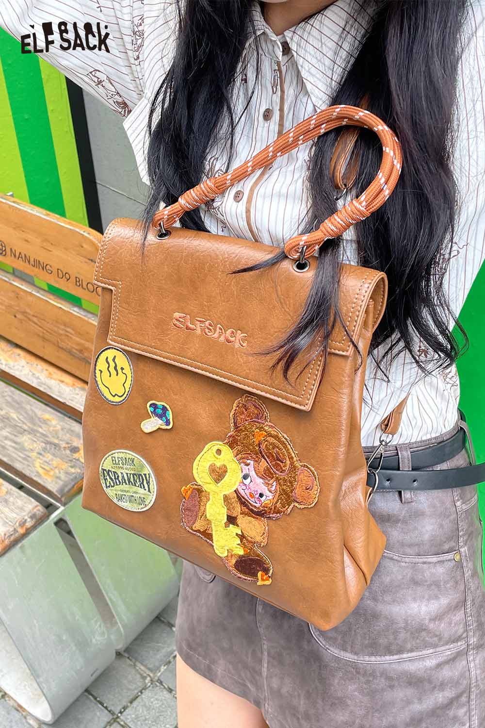 ELFSACK playful embroidery PU leather backpack with colorful patches and a braided handle