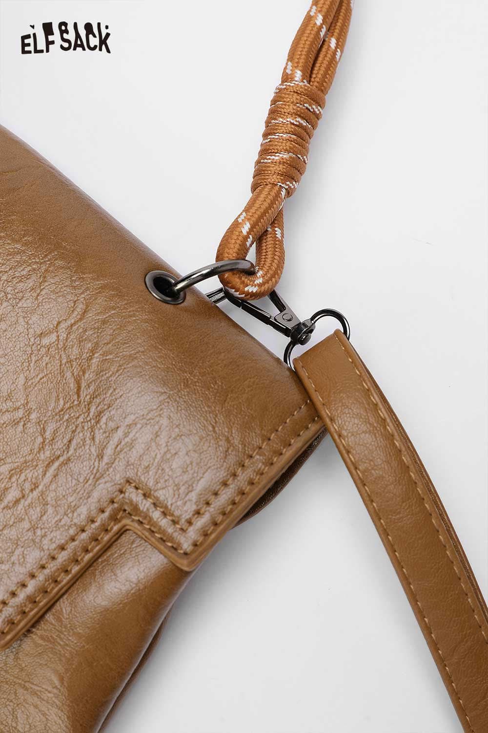 Close-up of ELFSACK playful embroidery PU leather backpack with detailed stitching and unique strap