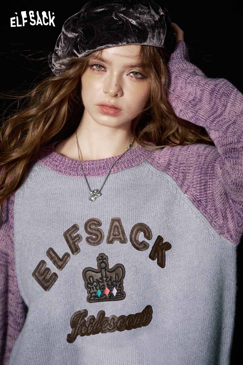ELFSACK soft graphic knit sweater with purple sleeves and embroidered crown design for stylish comfort