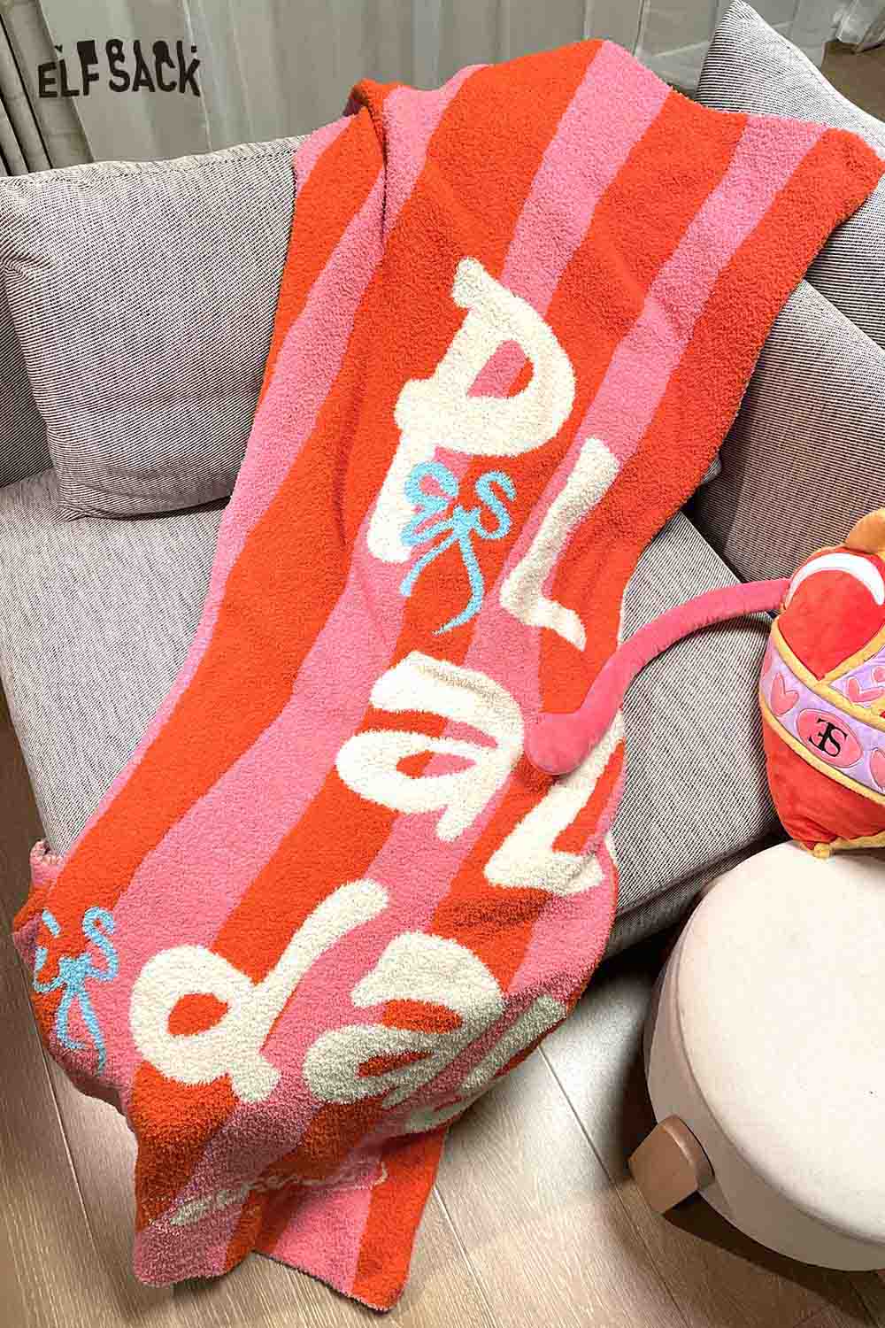 ELFSACK striped color block home blanket in vibrant pink and orange colors, perfect for cozying up at home