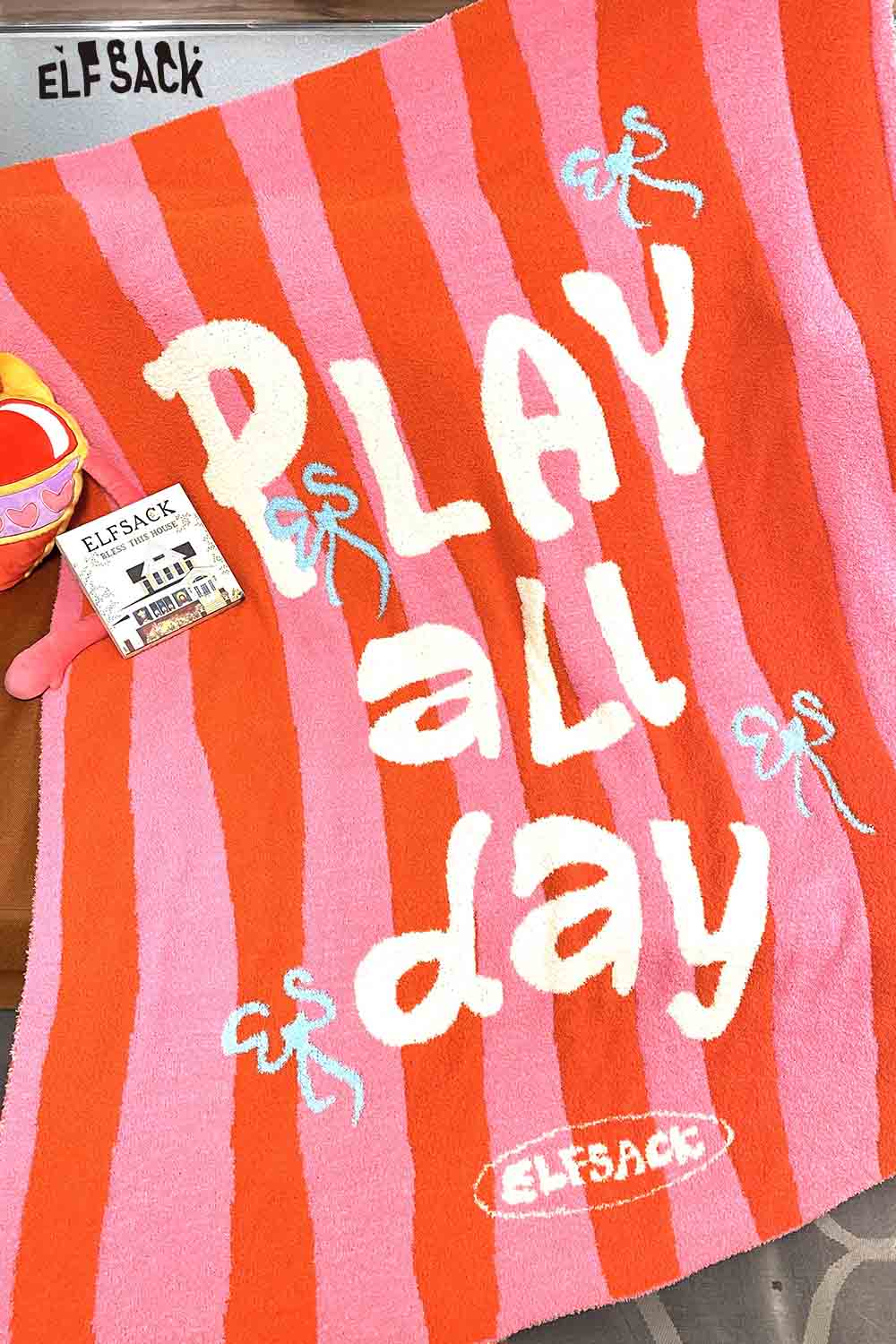 ELFSACK striped color block home blanket in pink and orange with playful text design