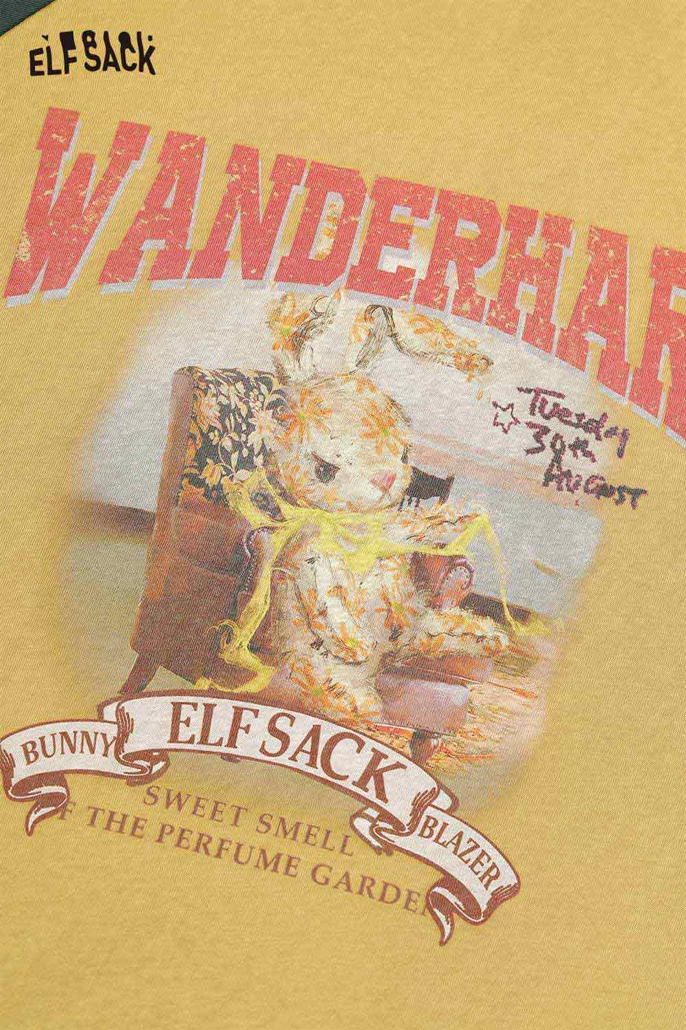 ELFSACK women's raglan sleeve graphic tee in mustard with a whimsical bunny design and playful text