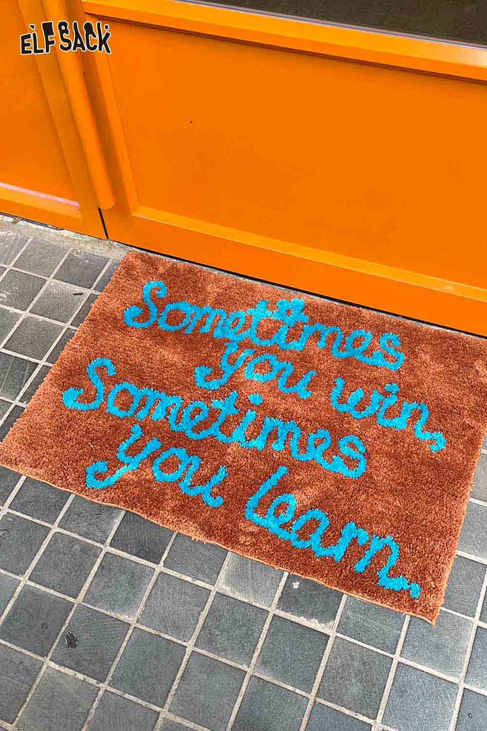 Felted wool rug with typography featuring the quote Sometimes you win Sometimes you learn in vibrant colors