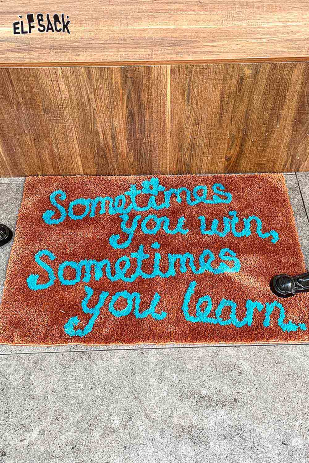 Felted wool rug with typography saying 'Sometimes you win, Sometimes you learn' in vibrant colors