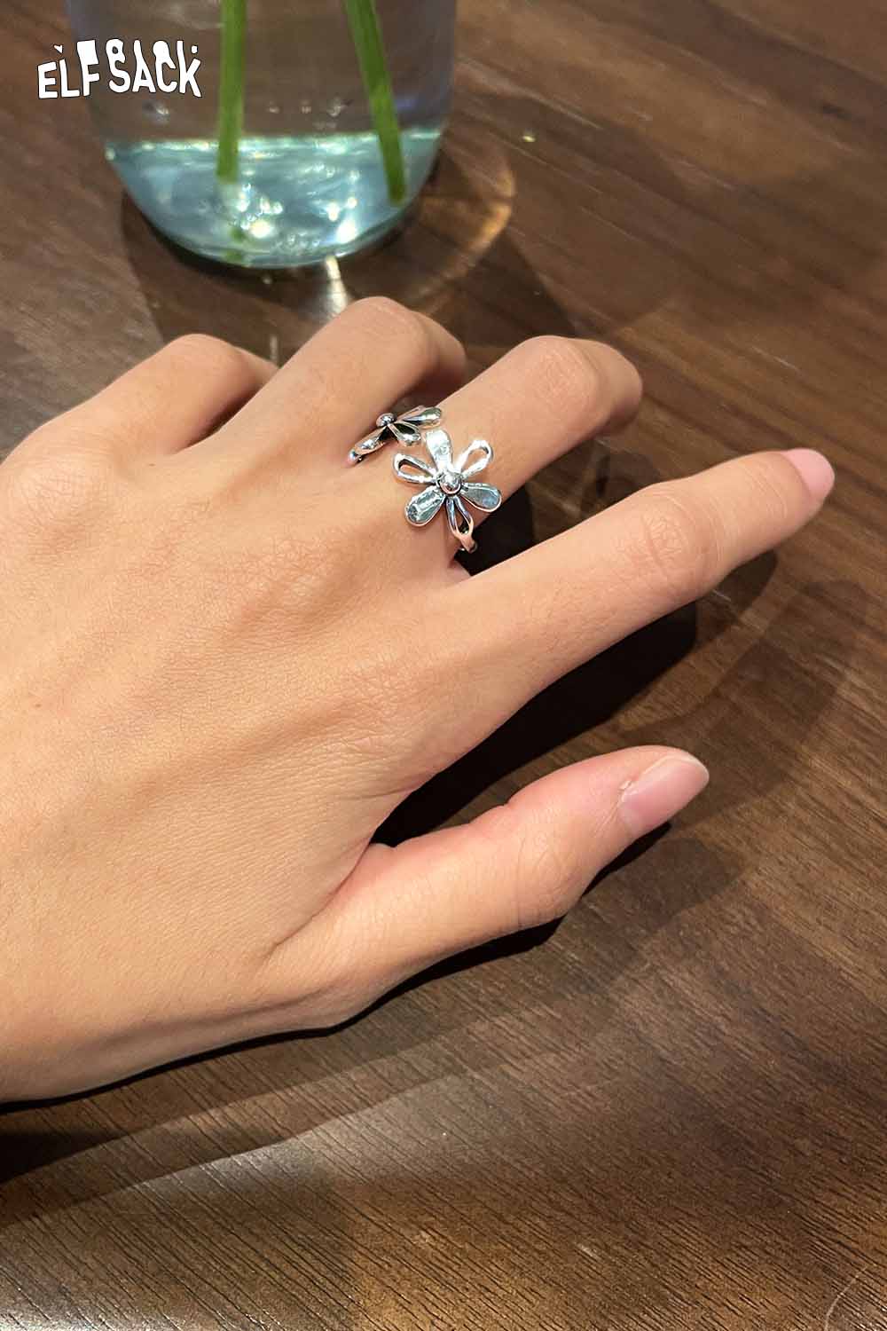 ELFSACK floral copper statement ring featuring a delicate flower design on a hand