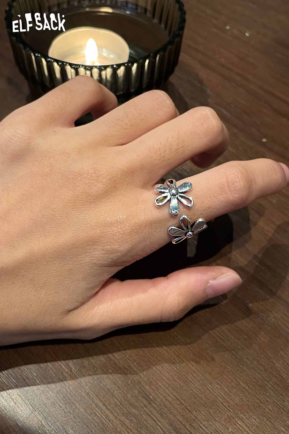 ELFSACK floral copper statement ring featuring a delicate flower design on a hand