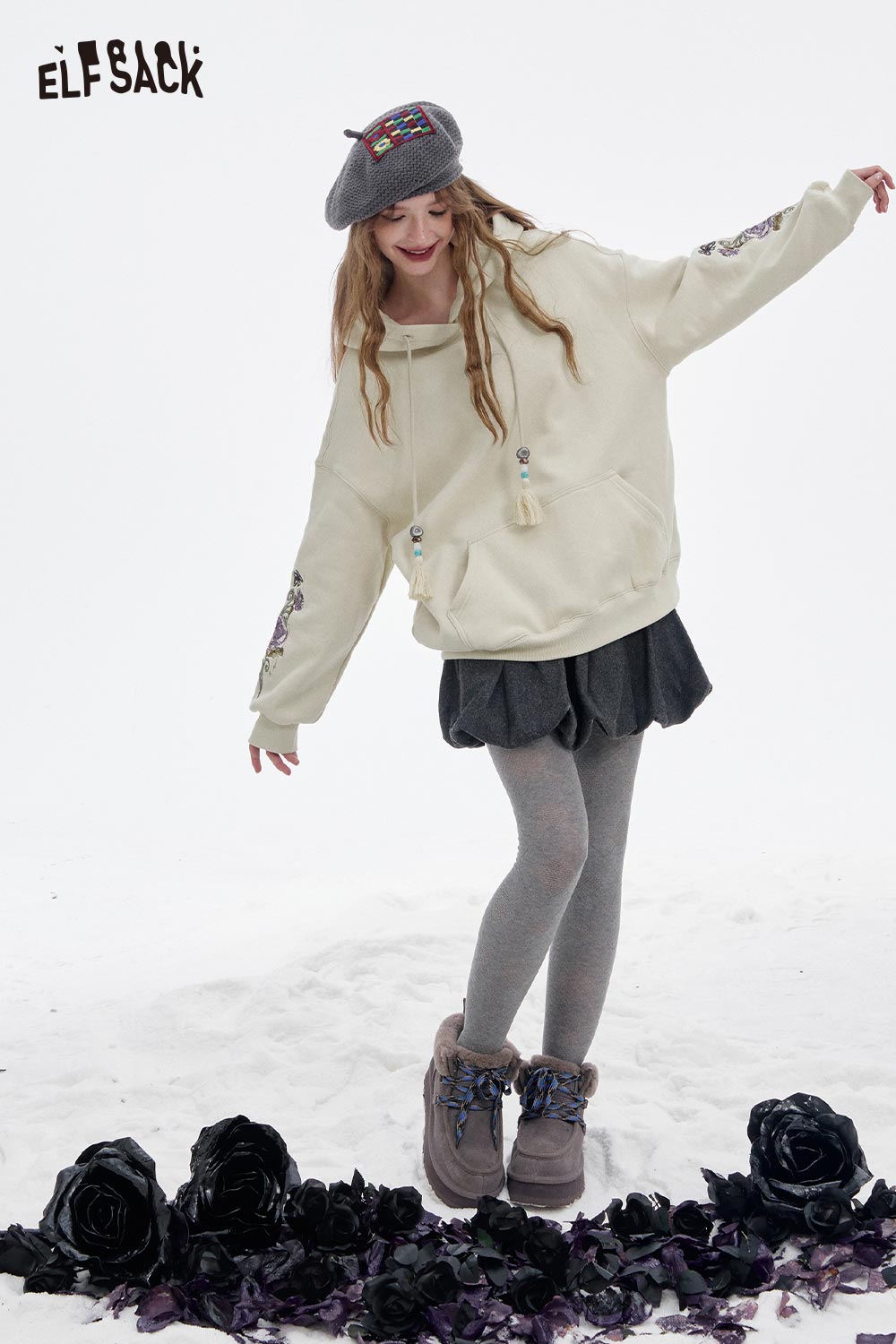 ELFSACK floral graphic tassel hoodie for women in light color, styled with a skirt and gray tights