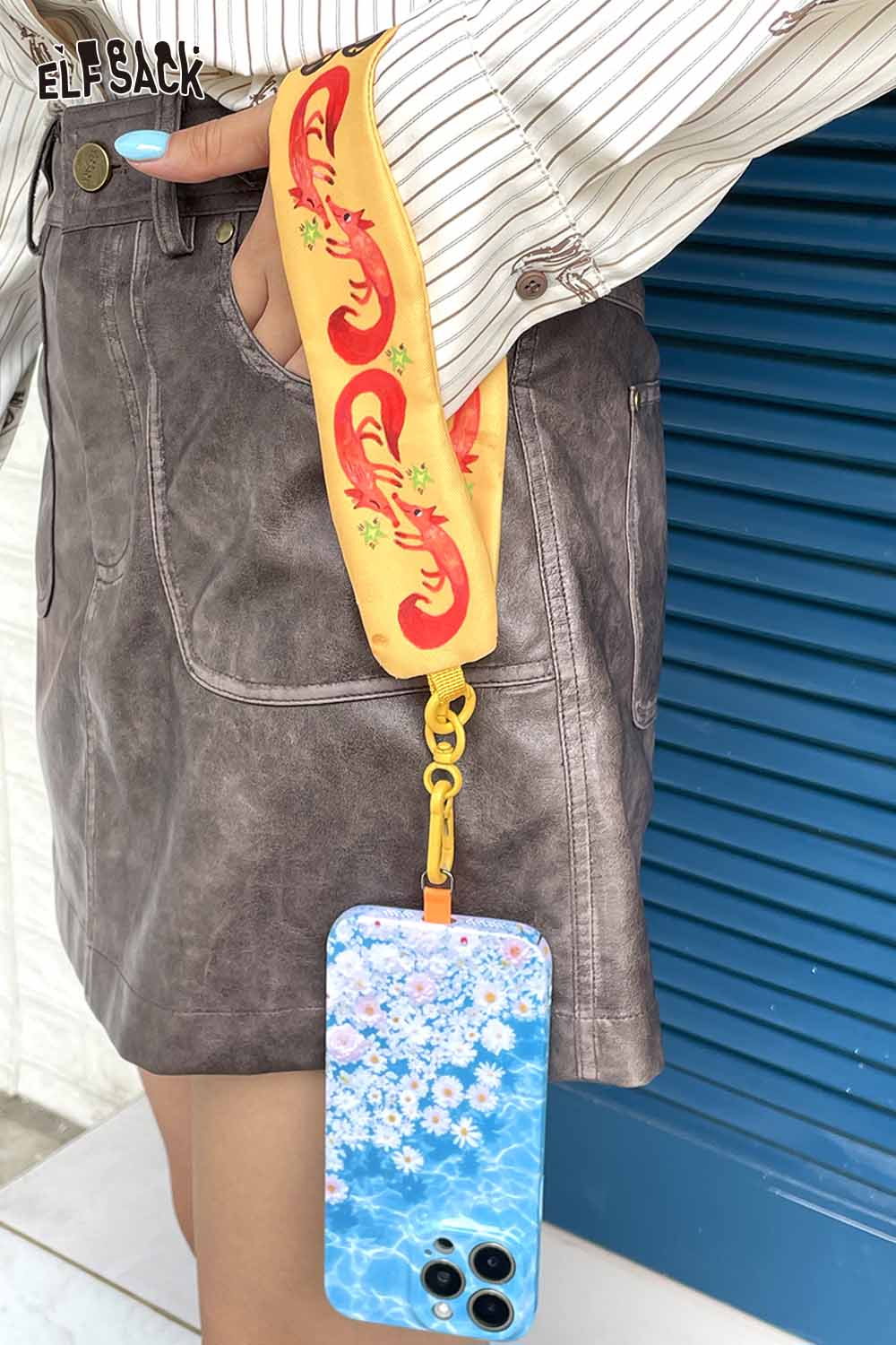 ELFSACK fox character phone strap with colorful floral patterns attached to a stylish phone