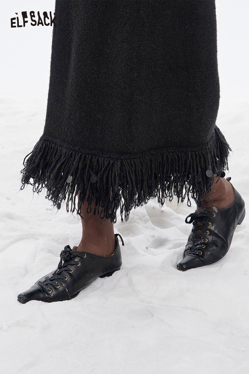 Black ELFSACK fringe hem long skirt featuring a stylish and unique fringe detail