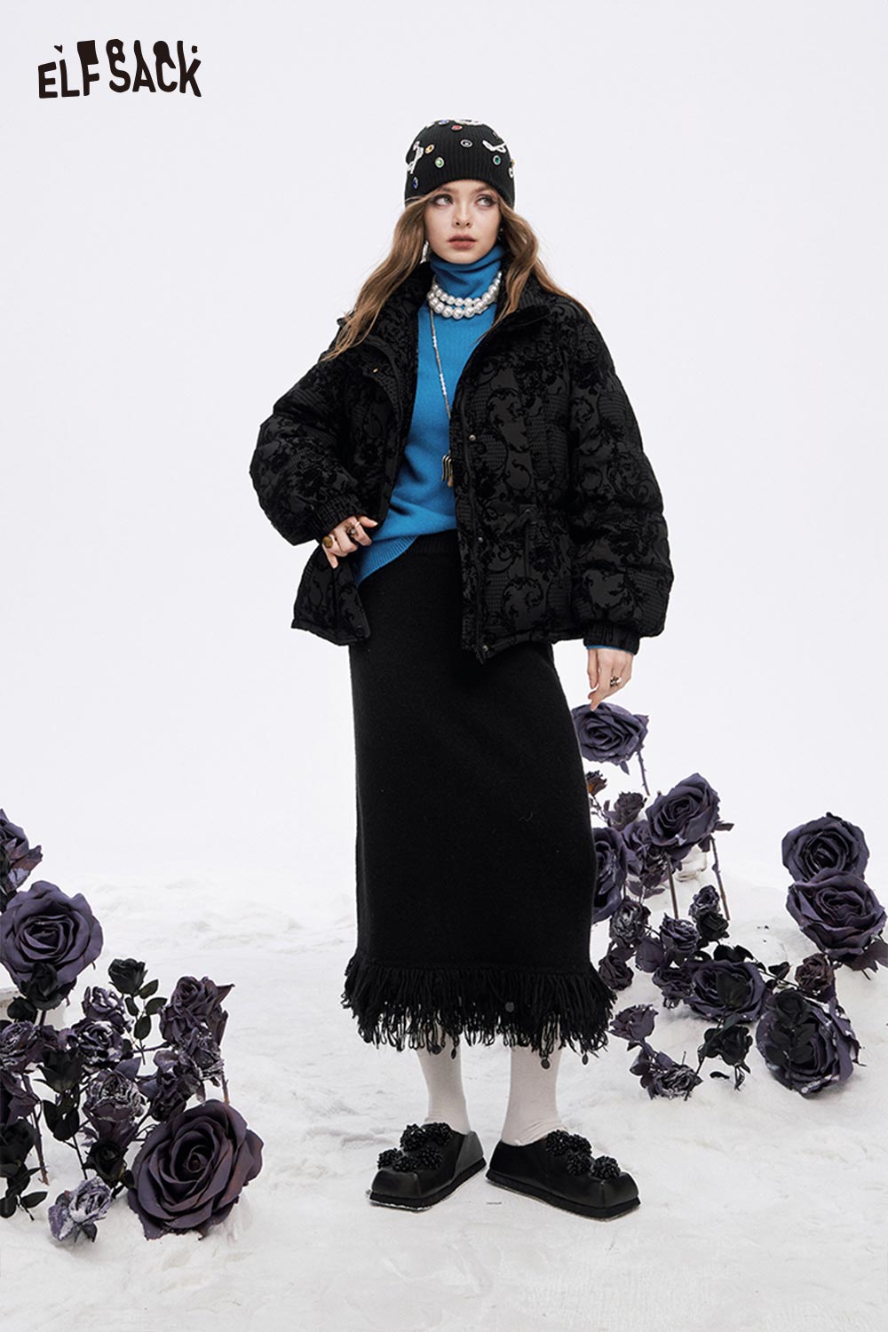 ELFSACK fringe hem long skirt paired with a black jacket and blue sweater for a stylish winter look