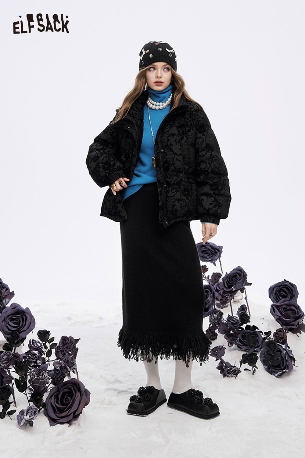 ELFSACK fringe hem long skirt paired with a black jacket and blue sweater for a stylish winter look