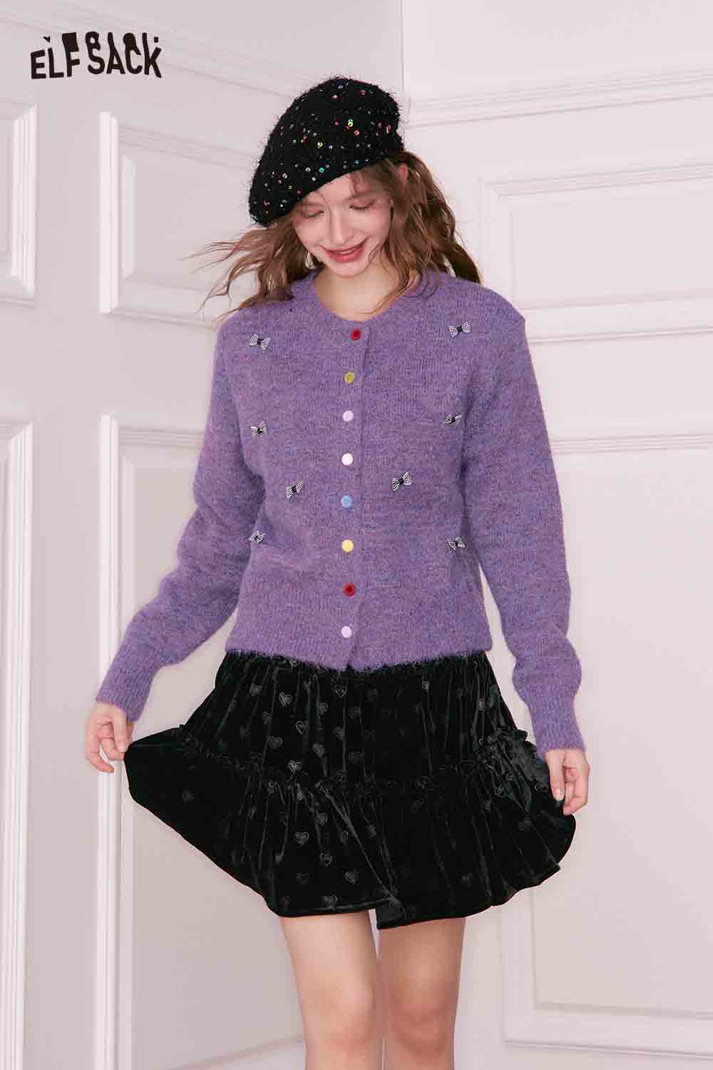 ELFSACK girly bow cardigan in purple with colorful buttons and sparkly details, styled with a black skirt