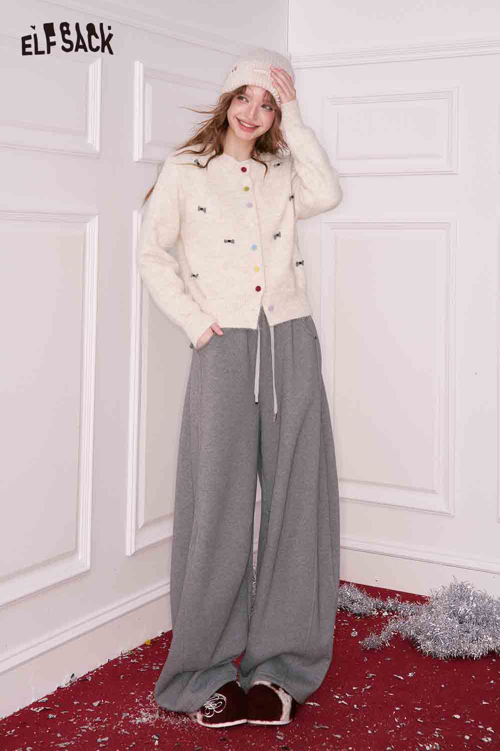 ELFSACK Girly Bow Cardigan in Cream with Colorful Buttons, paired with gray wide-leg pants