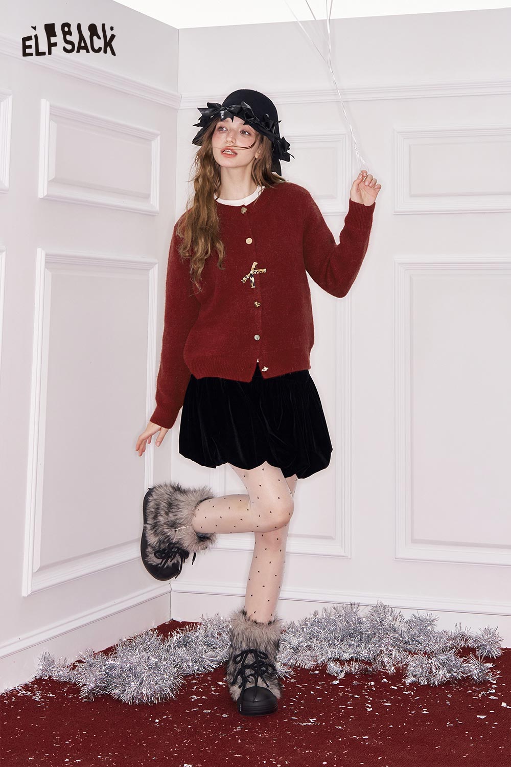 ELFSACK girly leopard bow cardigan in red, styled with a black skirt and winter accessories