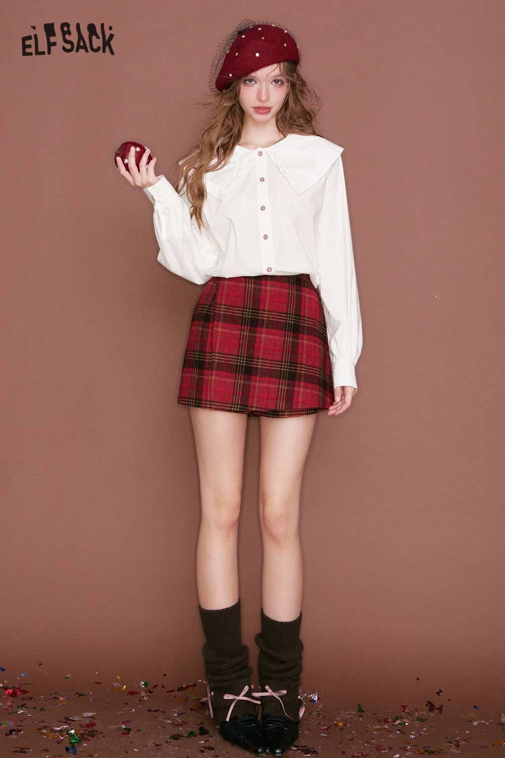 White ELFSACK heart collar blouse for women worn with a plaid skirt, ideal for stylish casual outfits
