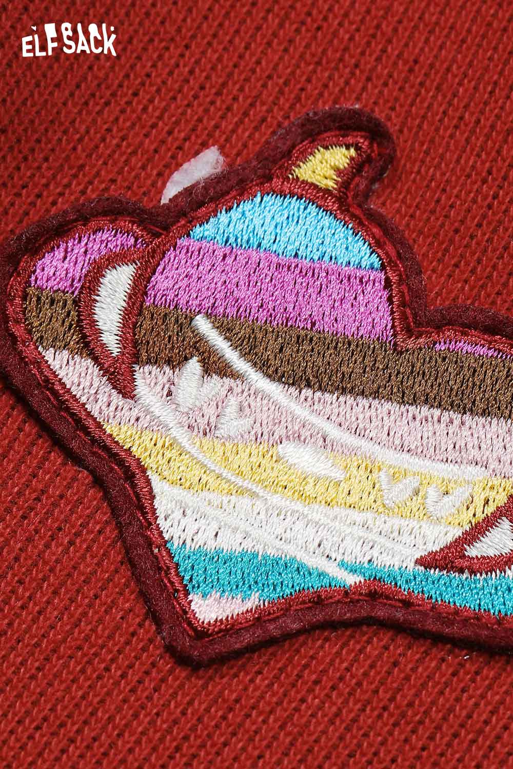 Close-up of heart embroidery on ELFSACK wide leg pants adding a playful touch to casual wear