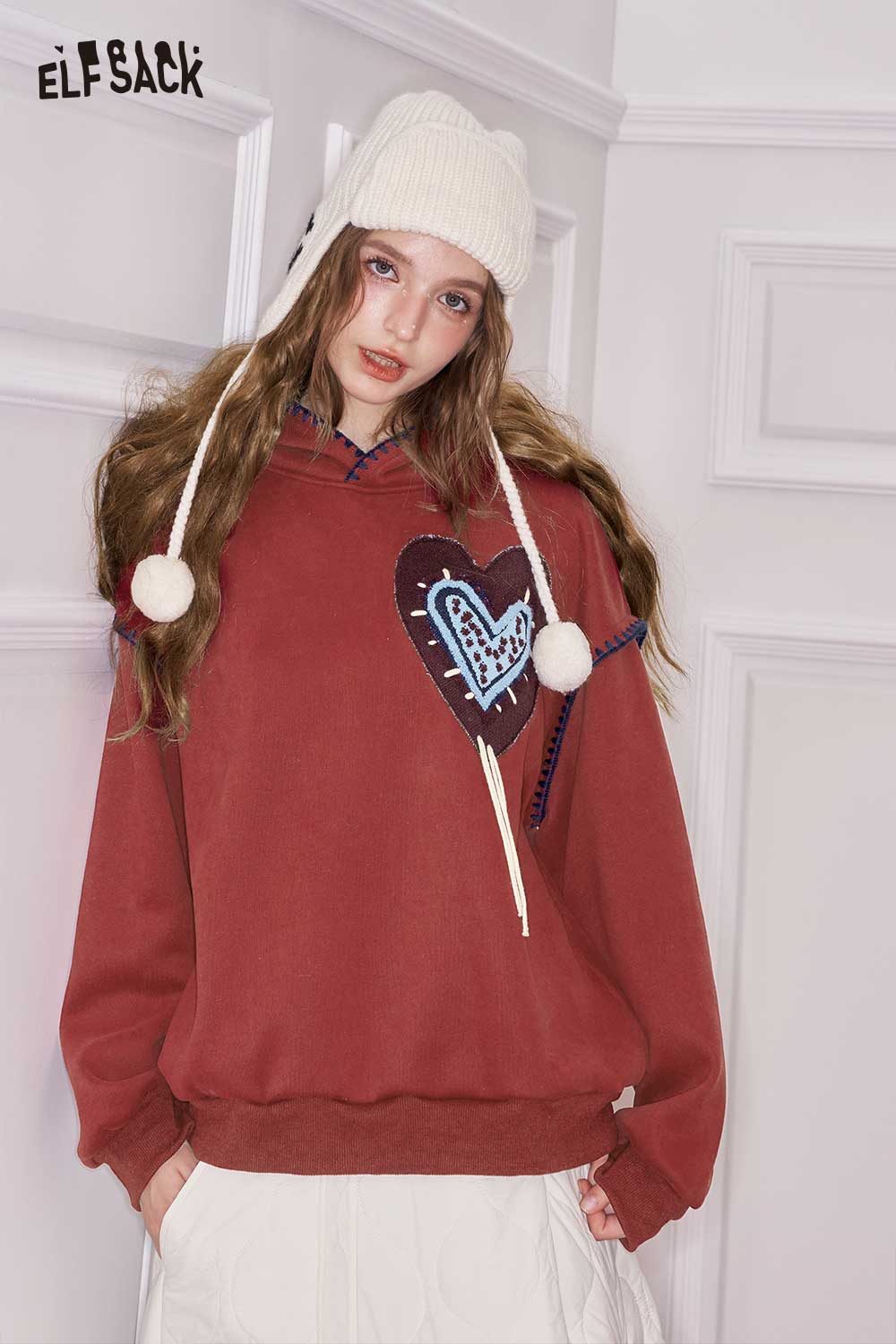 ELFSACK heart graphic collared sweatshirt in warm red with pom-pom details and a cozy hood
