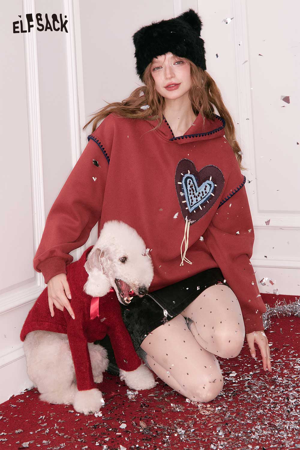 ELFSACK heart graphic collared sweatshirt with a playful design, styled with a cute dog and festive background
