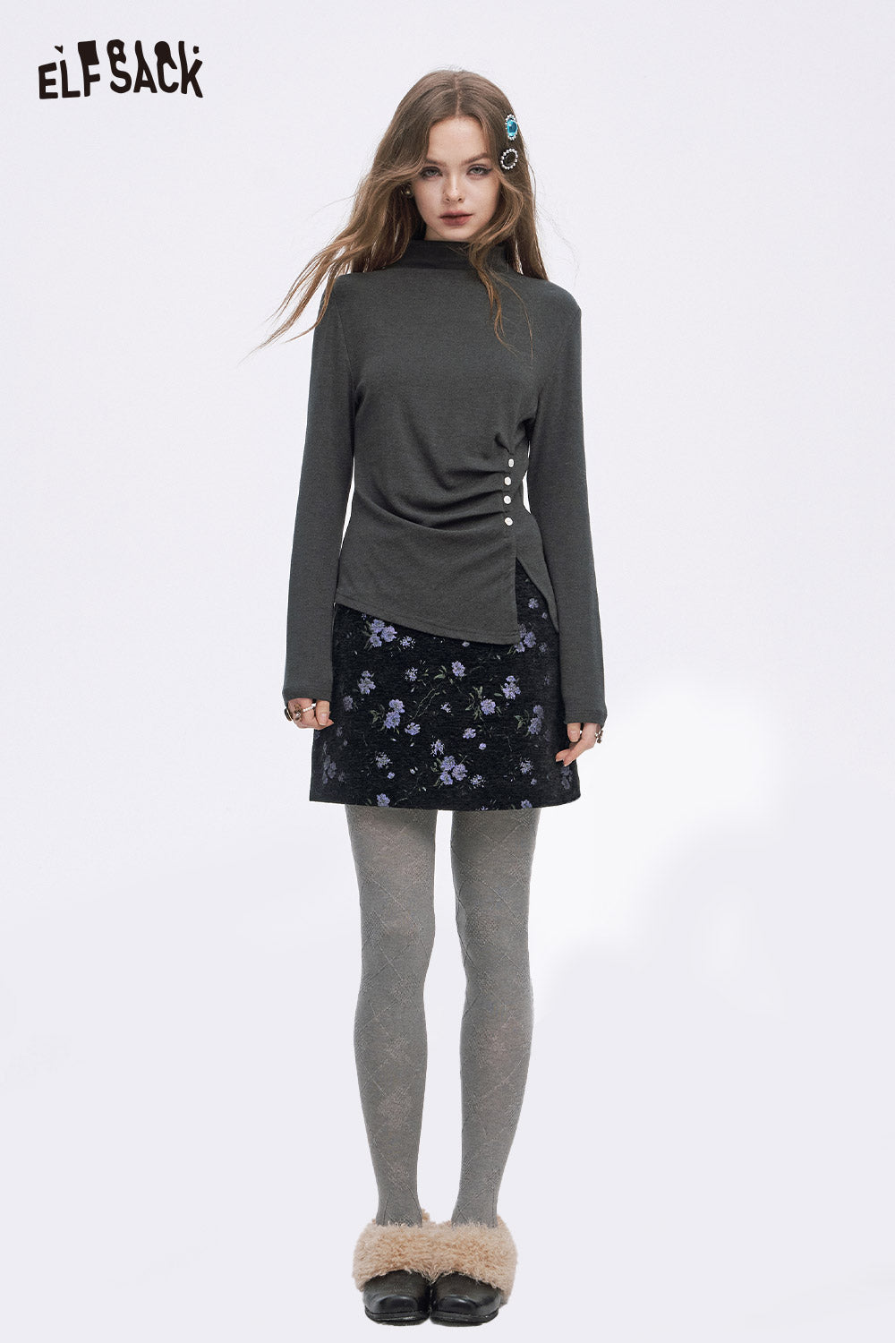 Model wearing a high waist floral A line skirt paired with a stylish long-sleeve top