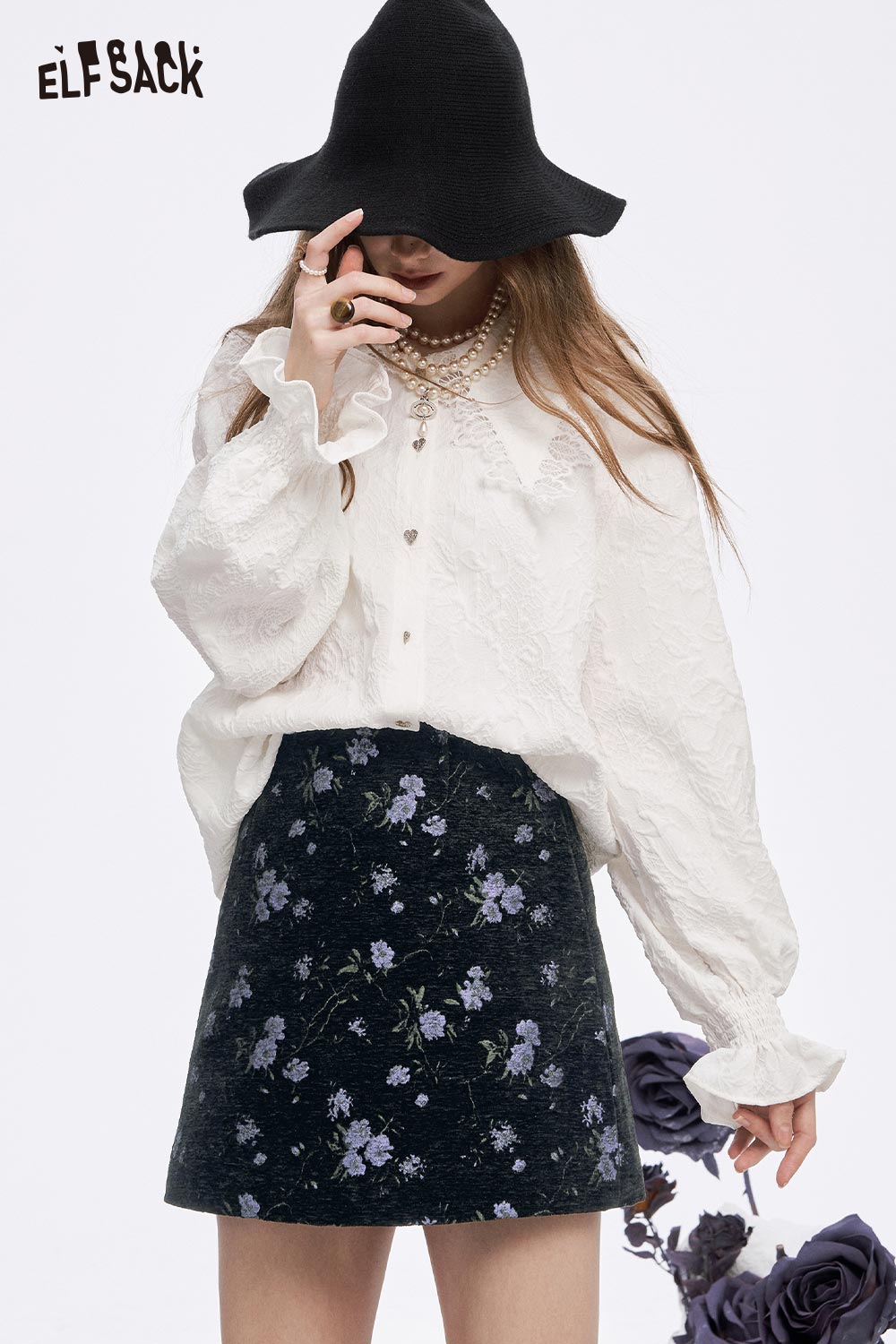 ELFSACK high waist floral A line skirt paired with a ruffled white blouse and wide-brimmed hat