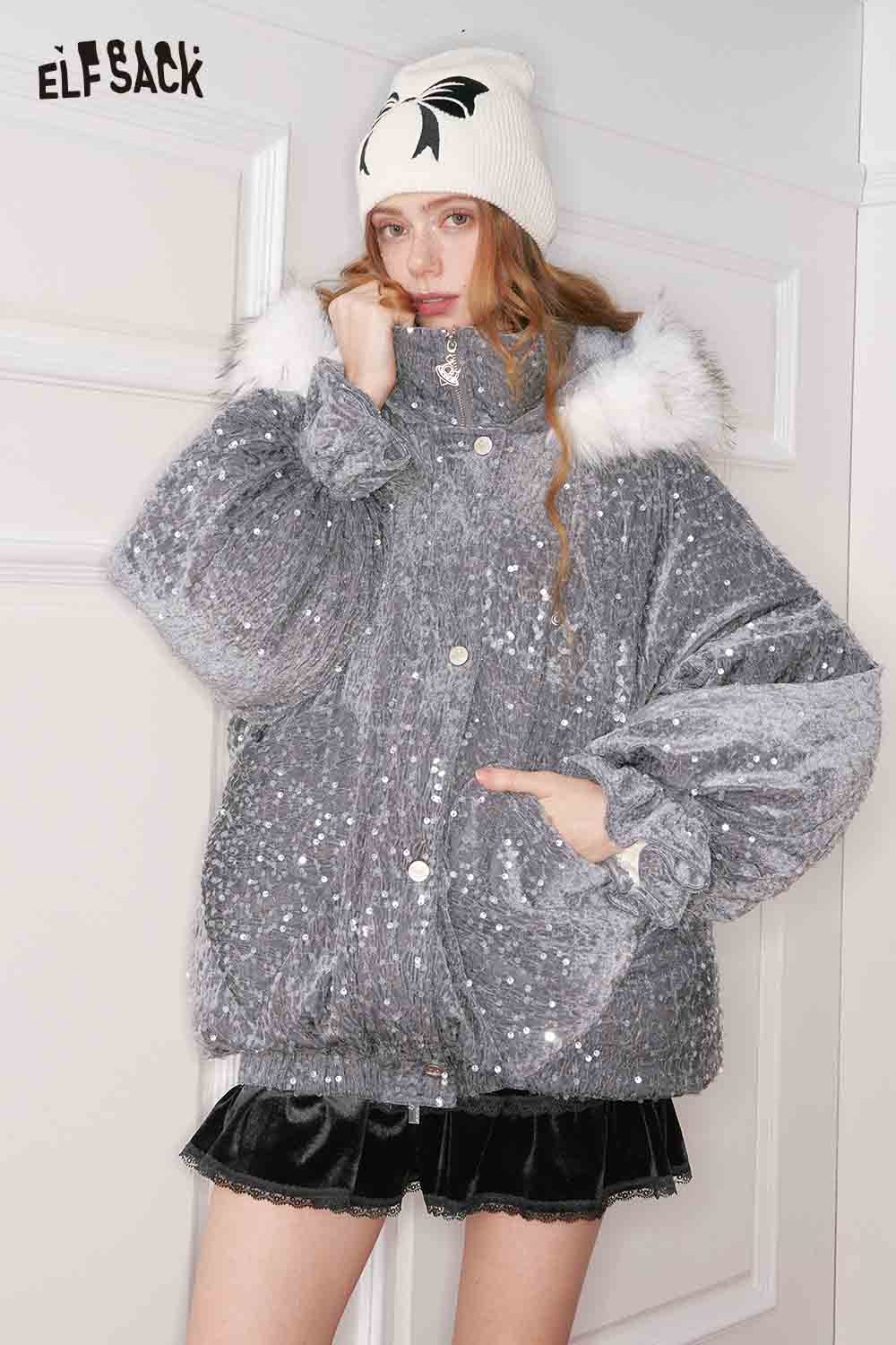 Model wearing a shiny ELFSACK jacket and a lace trim suede mini skirt, showcasing trendy winter fashion.