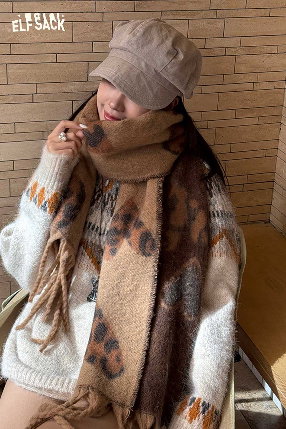 Cozy ELFSACK leopard heart fringe scarf styled with a warm sweater and cap for a trendy look