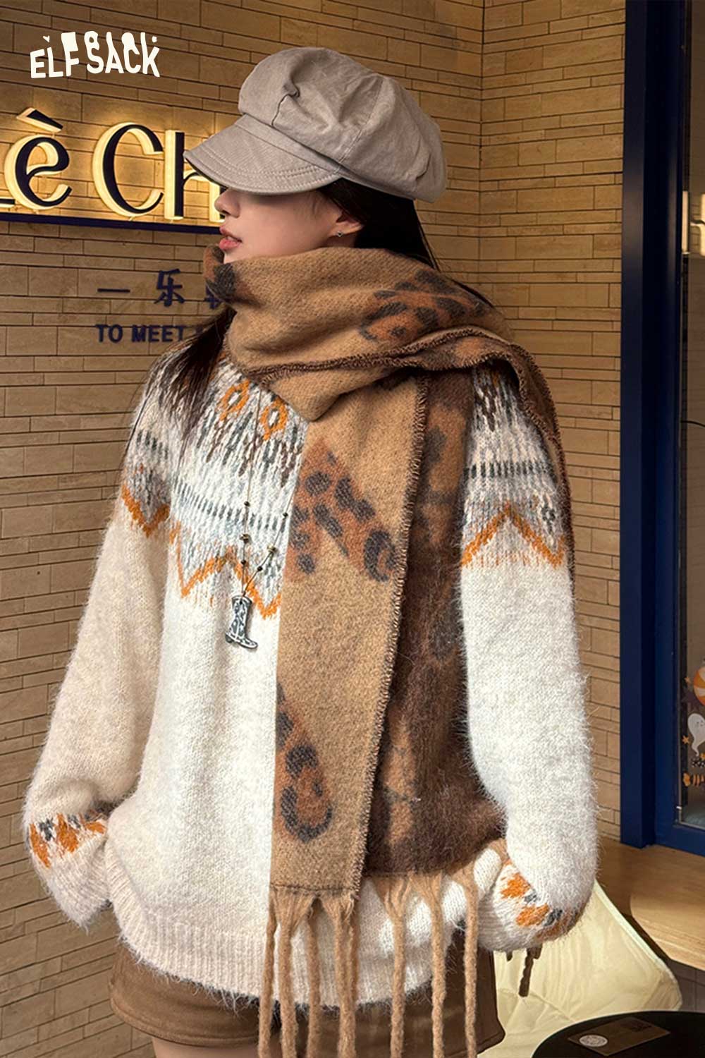 ELFSACK leopard heart fringe scarf in brown tones paired with a cozy sweater for winter style