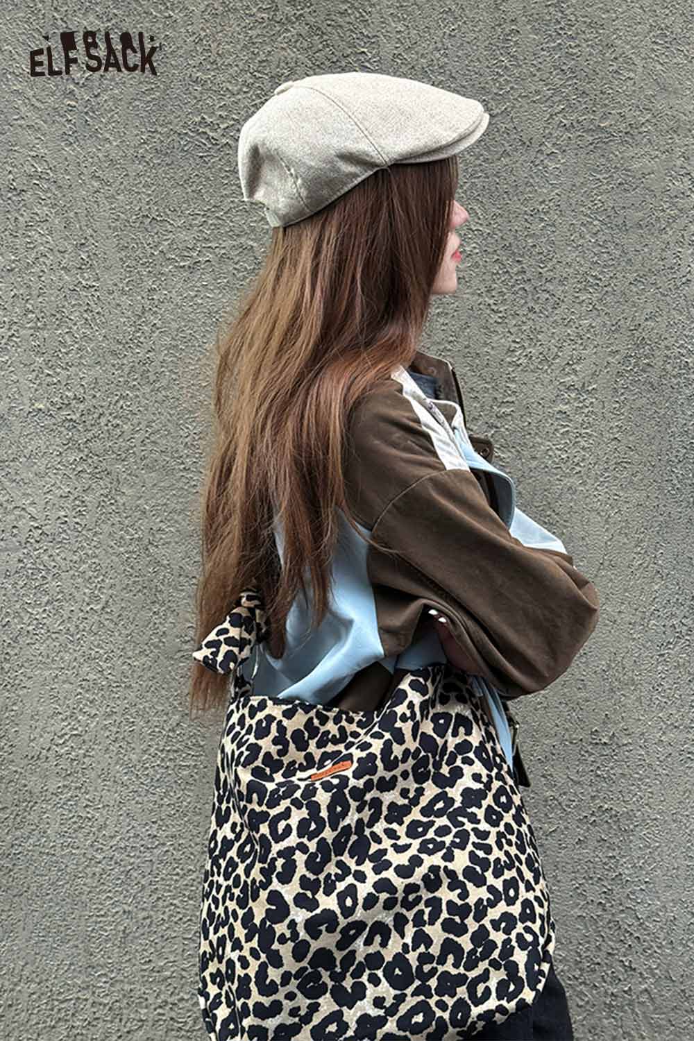 ELFSACK leopard print crossbody bag worn casually with stylish attire against a gray wall