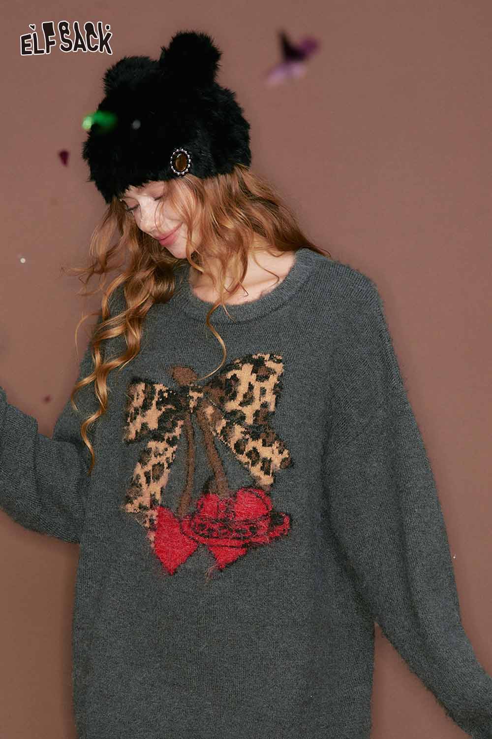 ELFSACK leopard print graphic sweater with a festive bow design for a cozy winter look