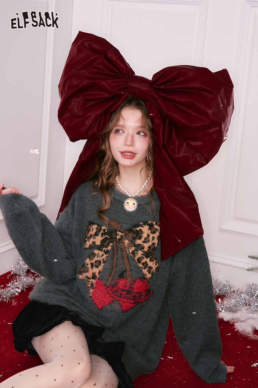 ELFSACK leopard print graphic sweater featuring a stylish bow design for a trendy look