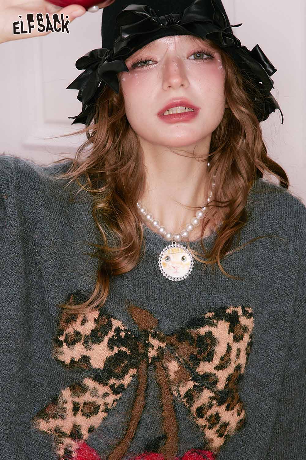 ELFSACK leopard print graphic sweater featuring a playful bow design and cozy fit